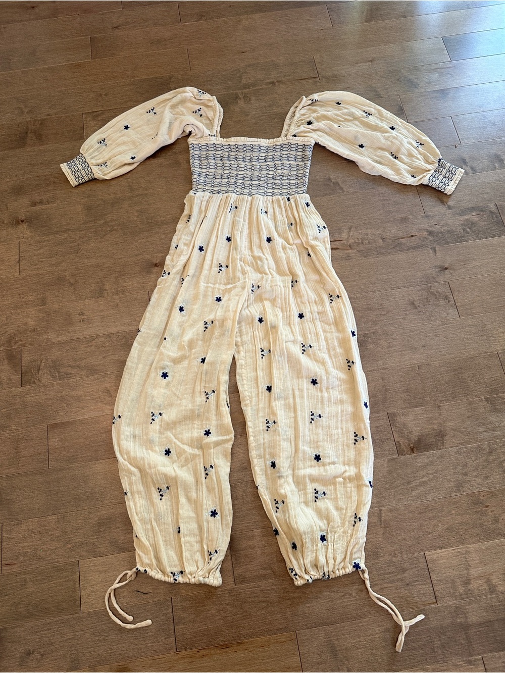 Free People Smocked Off-Shoulder Cream Jumpsuit with Blue Floral Embroidery